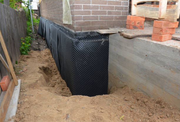 Happy homeowners after waterproofing job in Adams